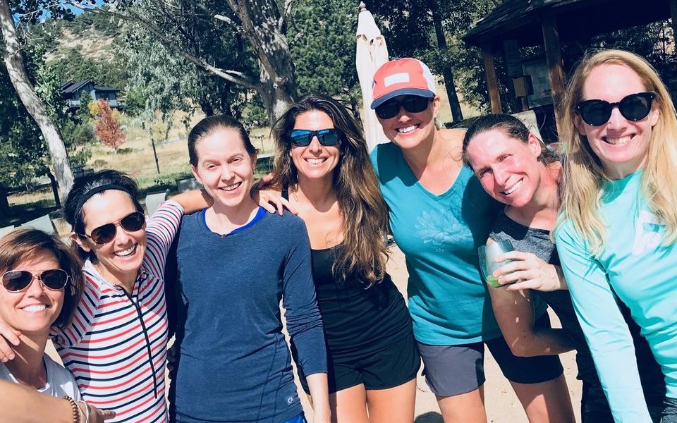 Six friends laughing together after a run in the park